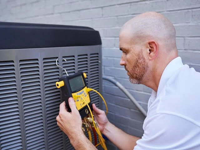 Technician testing electrical components of an HVAC system