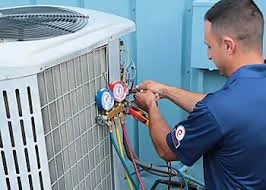 Technician checking pressure gauges on an outdoor air conditioner